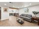 Finished basement living room featuring light wood floors and access to the updated kitchen at 2695 S Logan St, Denver, CO 80210
