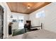 Finished basement with wood ceiling and access to a small kitchenette at 319 13Th Ave, Idaho Springs, CO 80452