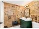 Charming bathroom with vintage newspaper wallpaper and a green vanity at 319 13Th Ave, Idaho Springs, CO 80452