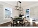 Bright dining area with whitewashed brick walls, hardwood floors, and large windows at 319 13Th Ave, Idaho Springs, CO 80452