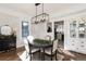 Elegant dining room featuring whitewashed brick, chandelier and a dark wood table at 319 13Th Ave, Idaho Springs, CO 80452