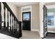 Front entry with black front door and patterned tile floor, plus a view of the sunroom at 319 13Th Ave, Idaho Springs, CO 80452