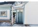 Side view of the house showcasing the blue door and landscaping at 319 13Th Ave, Idaho Springs, CO 80452