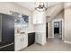 Updated kitchen featuring white cabinets, patterned tile floor and new appliances at 319 13Th Ave, Idaho Springs, CO 80452