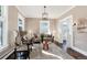 Bright living room featuring hardwood floors, a cozy sitting area, and stained-glass windows at 319 13Th Ave, Idaho Springs, CO 80452