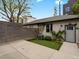 Backyard featuring concrete patio, artificial turf, and fenced perimeter, perfect for outdoor living at 3841 Stuart St, Denver, CO 80212