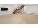 Large finished basement space with stairs and wall-mounted television at 3841 Stuart St, Denver, CO 80212