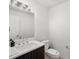 Modern half bathroom featuring sleek vanity with chrome faucet and contemporary lighting fixture at 3841 Stuart St, Denver, CO 80212