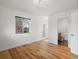 Empty bedroom with a large window, hardwood floors, and a modern design at 3841 Stuart St, Denver, CO 80212