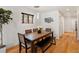 Bright dining area with hardwood floors, modern lighting, and stylish decor for comfortable dining at 3841 Stuart St, Denver, CO 80212
