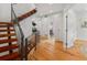 Bright foyer with hardwood floors, modern staircase, and neutral paint, leading to other rooms at 3841 Stuart St, Denver, CO 80212
