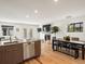 Bright, open-concept living and dining area with hardwood floors, fireplace, and modern furnishings at 3841 Stuart St, Denver, CO 80212