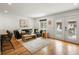 Cozy living room features hardwood floors, a comfortable sectional sofa, and plenty of natural light at 3841 Stuart St, Denver, CO 80212