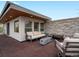 Spacious outdoor patio area with modern furniture, fire pit, and privacy wall at 3841 Stuart St, Denver, CO 80212