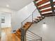 Modern staircase with wood treads, steel railings, and natural light at 3841 Stuart St, Denver, CO 80212