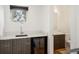 Wet bar with cabinets, a sink and view into the bathroom at 3841 Stuart St, Denver, CO 80212
