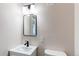 Modern bathroom featuring a sleek mirror, contemporary vanity, and a toilet at 1969 Uinta St, Denver, CO 80220