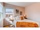 Sun-filled bedroom featuring a comfortable bed and windows, with hardwood floors at 1969 Uinta St, Denver, CO 80220