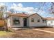 Charming single-story home featuring light-colored siding, a front yard, and a well-maintained landscape at 1969 Uinta St, Denver, CO 80220