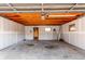 Unfinished garage featuring concrete floor, exposed ceiling, and a ladder, presenting customization potential at 1969 Uinta St, Denver, CO 80220