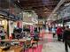 An indoor market with tables and seating, offering a variety of food and retail vendors in a bustling atmosphere at 1969 Uinta St, Denver, CO 80220