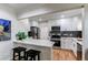 Charming kitchen features white cabinets, stainless appliances, breakfast bar seating at 1969 Uinta St, Denver, CO 80220