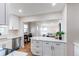 Open concept kitchen leads to a living room filled with natural light at 1969 Uinta St, Denver, CO 80220