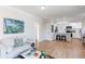 Open-concept living room flows into the kitchen with hardwood floors and ample lighting at 1969 Uinta St, Denver, CO 80220