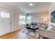 Bright living room with hardwood floors, neutral paint, and a view of the front yard at 1969 Uinta St, Denver, CO 80220