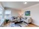 Cozy living room with hardwood floors, neutral paint, and natural light from a large window at 1969 Uinta St, Denver, CO 80220
