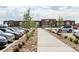 Exterior view of a retail center with ample parking and landscaped walkway at 1969 Uinta St, Denver, CO 80220
