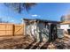 Yard shed adjacent to a wood fence at 1969 Uinta St, Denver, CO 80220