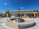 An outdoor shopping plaza with a fire pit feature and nearby shops for community gathering and commerce at 1969 Uinta St, Denver, CO 80220