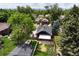 Aerial view of a home showcasing its backyard, neighborhood, and city views in the distance at 2636 N Glencoe St, Denver, CO 80207