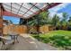 Backyard patio area with seating overlooking a lush lawn and fenced yard, perfect for entertaining at 2636 N Glencoe St, Denver, CO 80207
