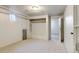 Finished basement featuring built-in shelving and storage, with a neutral carpet and white painted walls at 2636 N Glencoe St, Denver, CO 80207