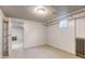 Basement space with carpet and painted walls, featuring a classic radiator and open doorway at 2636 N Glencoe St, Denver, CO 80207