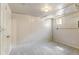 Neutral basement space with carpet, painted walls, and a small window letting in natural light at 2636 N Glencoe St, Denver, CO 80207