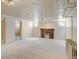 Spacious basement with carpeted floors, brick fireplace, and classic radiator at 2636 N Glencoe St, Denver, CO 80207