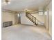 Basement with staircase, radiator, and neutral carpet at 2636 N Glencoe St, Denver, CO 80207