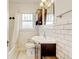 Classic bathroom featuring white subway tile, vanity, and vintage lighting at 2636 N Glencoe St, Denver, CO 80207