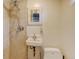 Small bathroom with shower, sink, and wall-mounted mirror at 2636 N Glencoe St, Denver, CO 80207