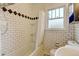 Vintage bathroom featuring white subway tile, overhead shower, and classic tub at 2636 N Glencoe St, Denver, CO 80207