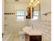 Bathroom with white subway tile, a dark vanity, and classic fixtures at 2636 N Glencoe St, Denver, CO 80207