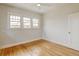 Bright bedroom with hardwood floors, ceiling fan, and sunny windows at 2636 N Glencoe St, Denver, CO 80207
