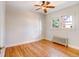 Bedroom with wood floors, ceiling fan, and multiple windows at 2636 N Glencoe St, Denver, CO 80207