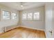 Bright bedroom featuring hardwood floors and multiple windows at 2636 N Glencoe St, Denver, CO 80207