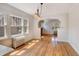 Dining room featuring hardwood floors, arched doorways, radiator heat and bright windows at 2636 N Glencoe St, Denver, CO 80207