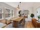 Elegant dining room with large windows, hardwood floors, and a modern chandelier, ideal for Gathering meals at 2636 N Glencoe St, Denver, CO 80207