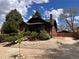 Charming brick home with mature landscaping and a sunny sky at 2636 N Glencoe St, Denver, CO 80207